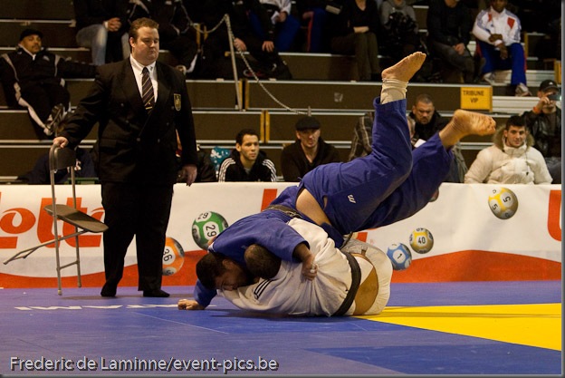 Visé - January 30 : Mohamed BOUAICHAOUI (blue) from Algeria compete with  Jallal BENALLA from France in the final match of Men's +100 Kg during the Judo Open International 2010 in Visé, Belgium. BOUAICHAOUI won the match.