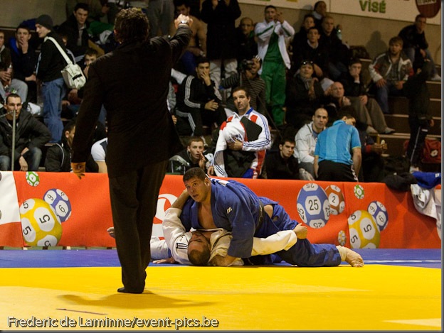 Visé - January 30 : Mohamed BOUAICHAOUI (blue) from Algeria compete with  Jallal BENALLA from France in the final match of Men's +100 Kg during the Judo Open International 2010 in Visé, Belgium. BOUAICHAOUI won the match.